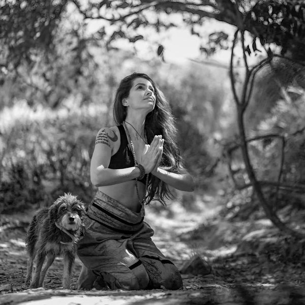 A serene woman in a meditative yoga pose with indigo and saffron colors.