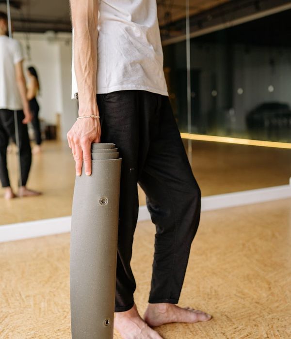 Person holding a challenging yoga pose, showcasing physical strength and balance.